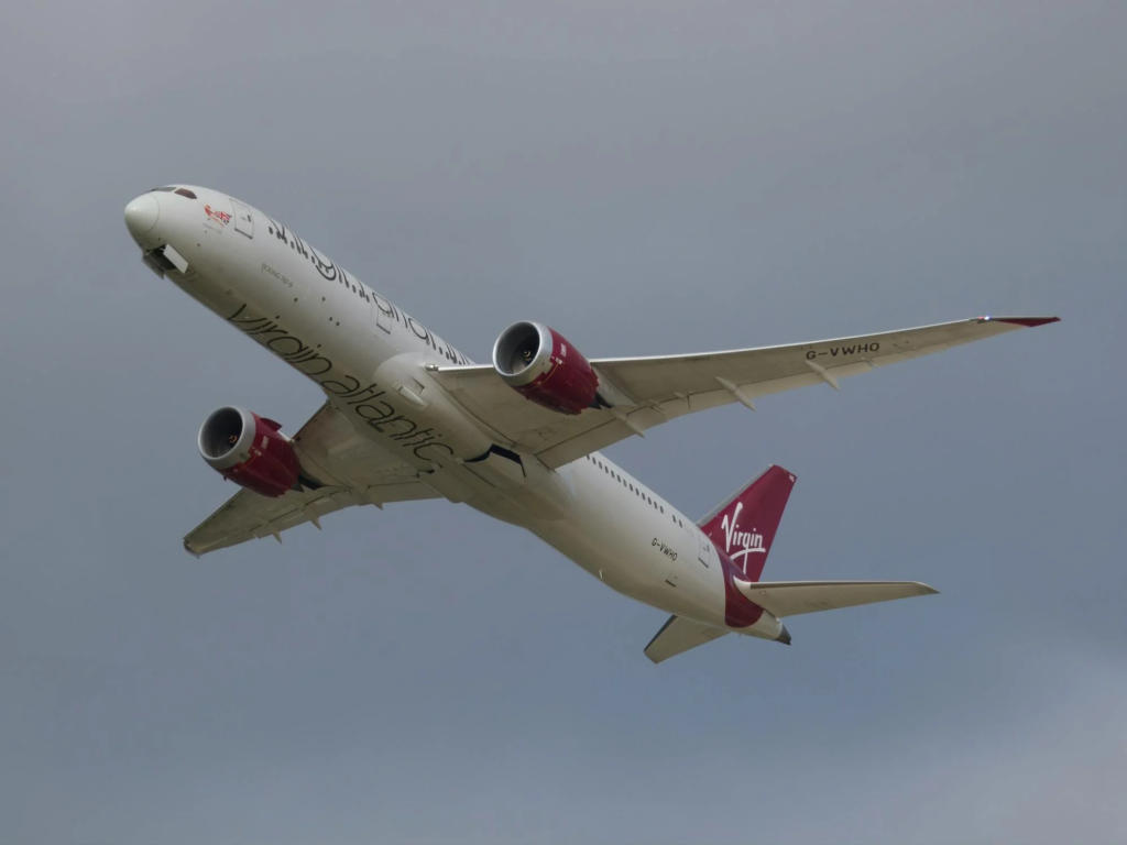 Virgin Atlantic Airbus A330-900 taking off with landing gear extended under cloudy skies