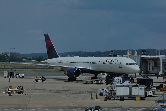 Delta Air Lines Boeing 757 parked at a gate at Ronald Reagan Washington National Airport.